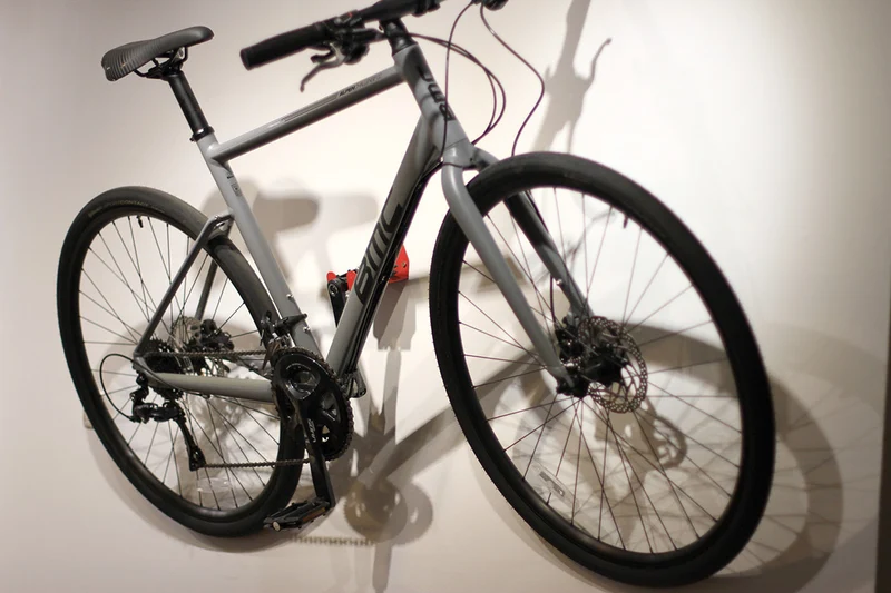 Wall-mounted bike rack with pedal attachment