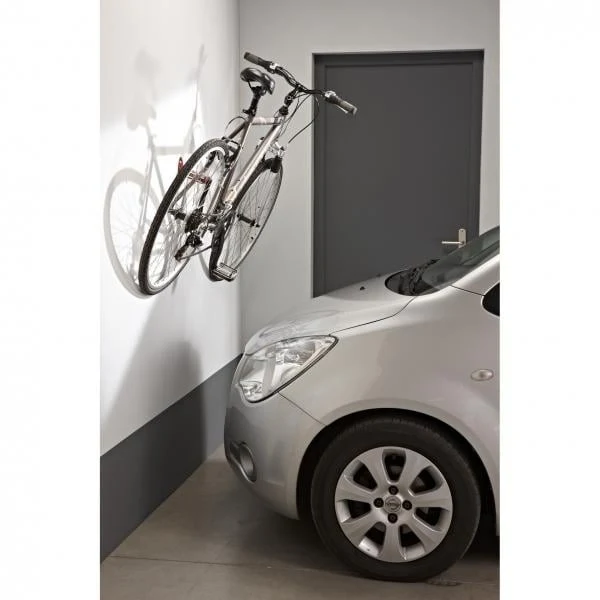 Wall-mounted bike rack with pedal attachment