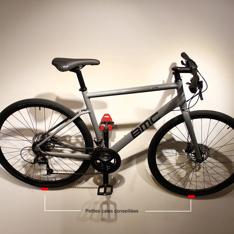 Wall-mounted bike rack with pedal attachment