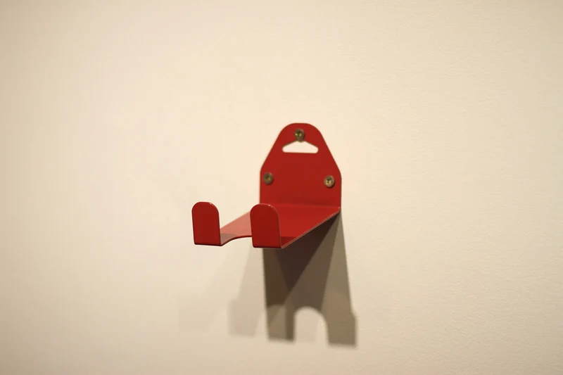 Wall-mounted bike rack with pedal attachment