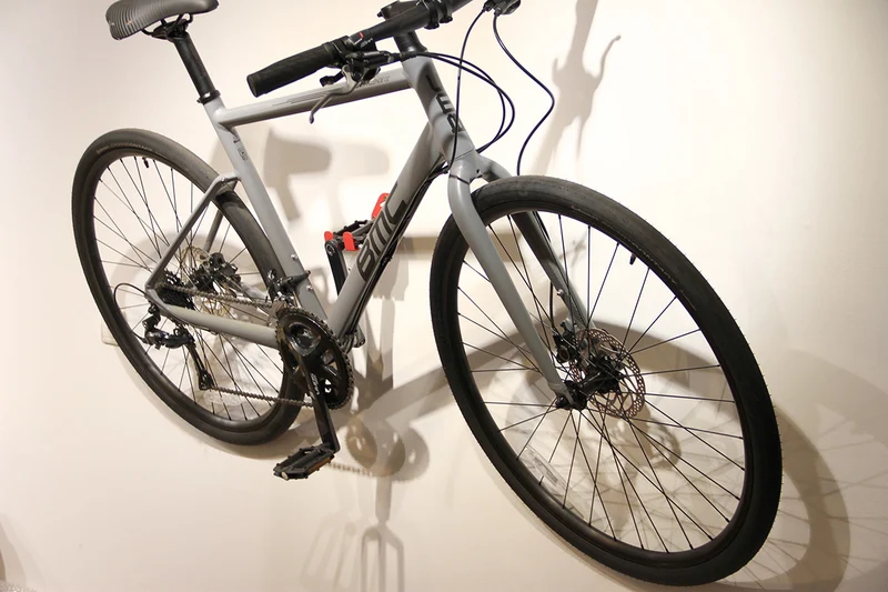 Wall-mounted bike rack with pedal attachment